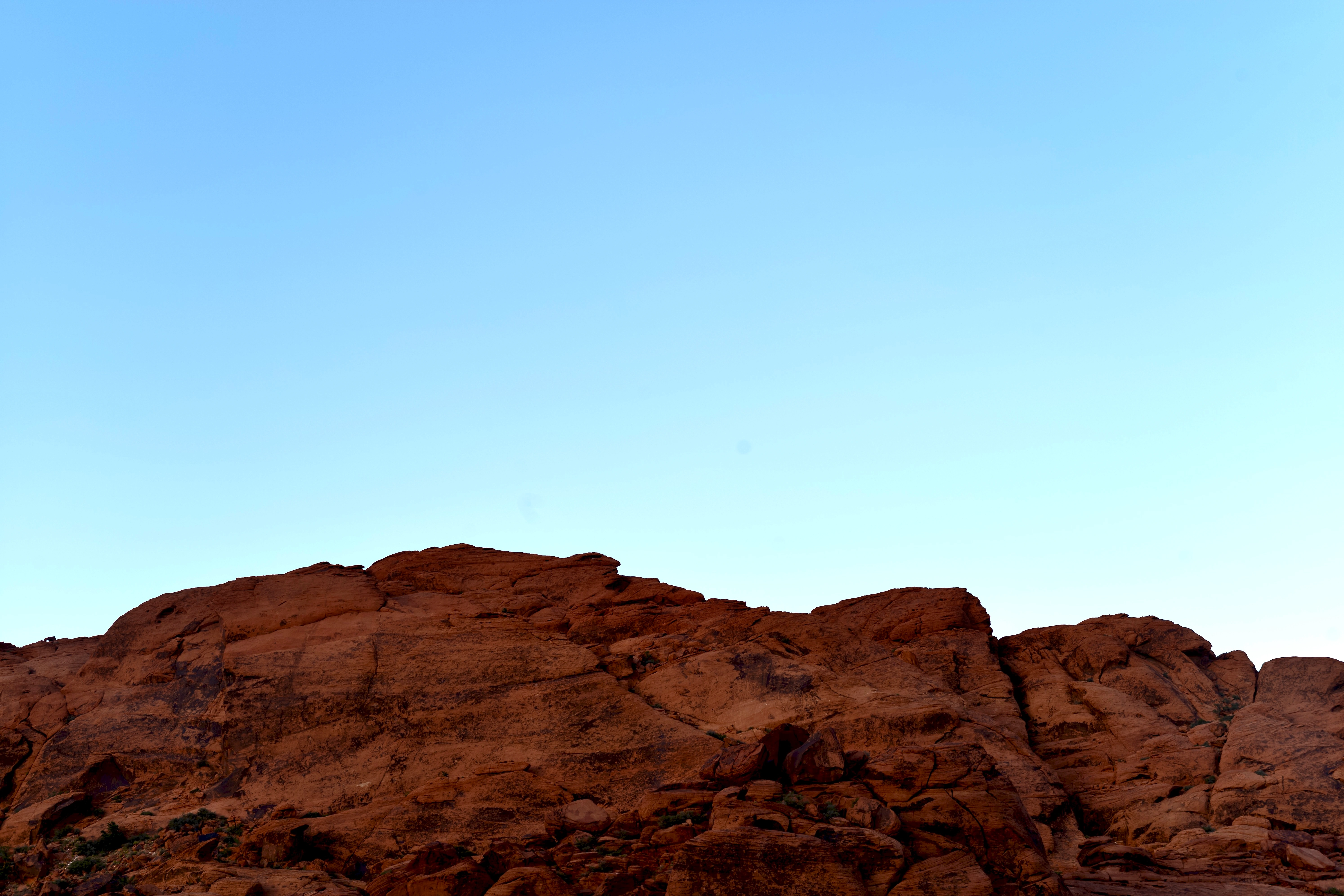 Red-sandstone-cliffs-under-clear-sky-scaled