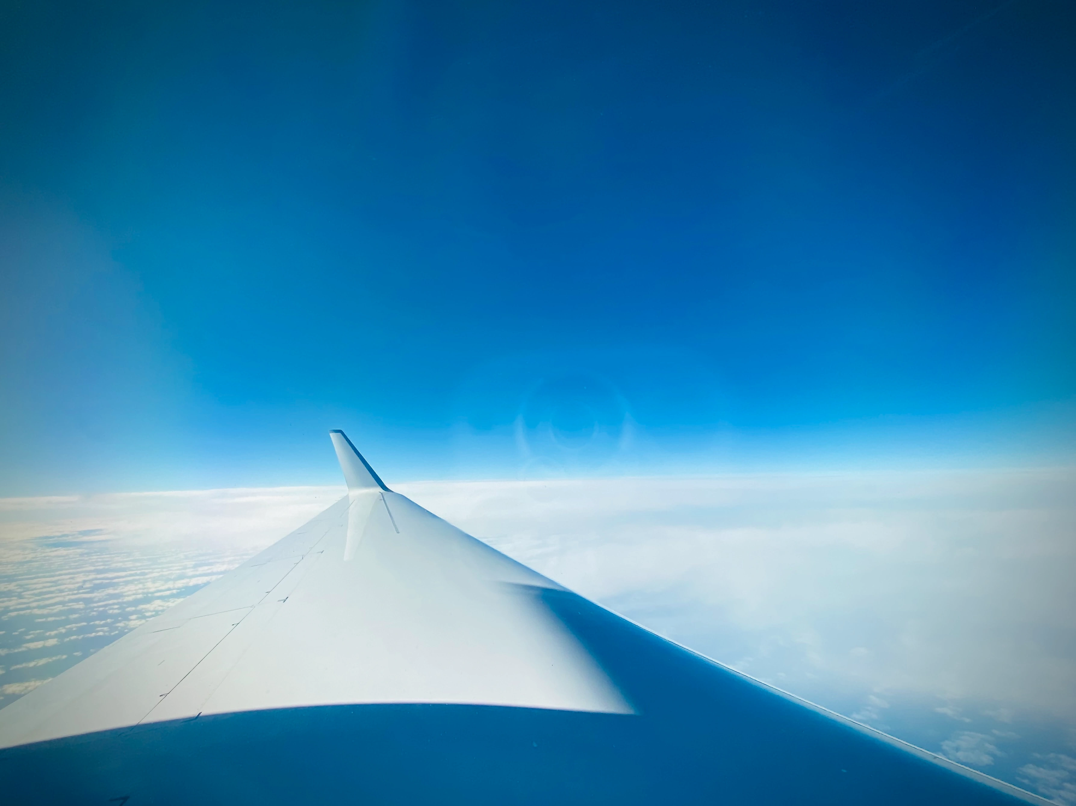 airplane-wing-above-clouds-during-day-scaled